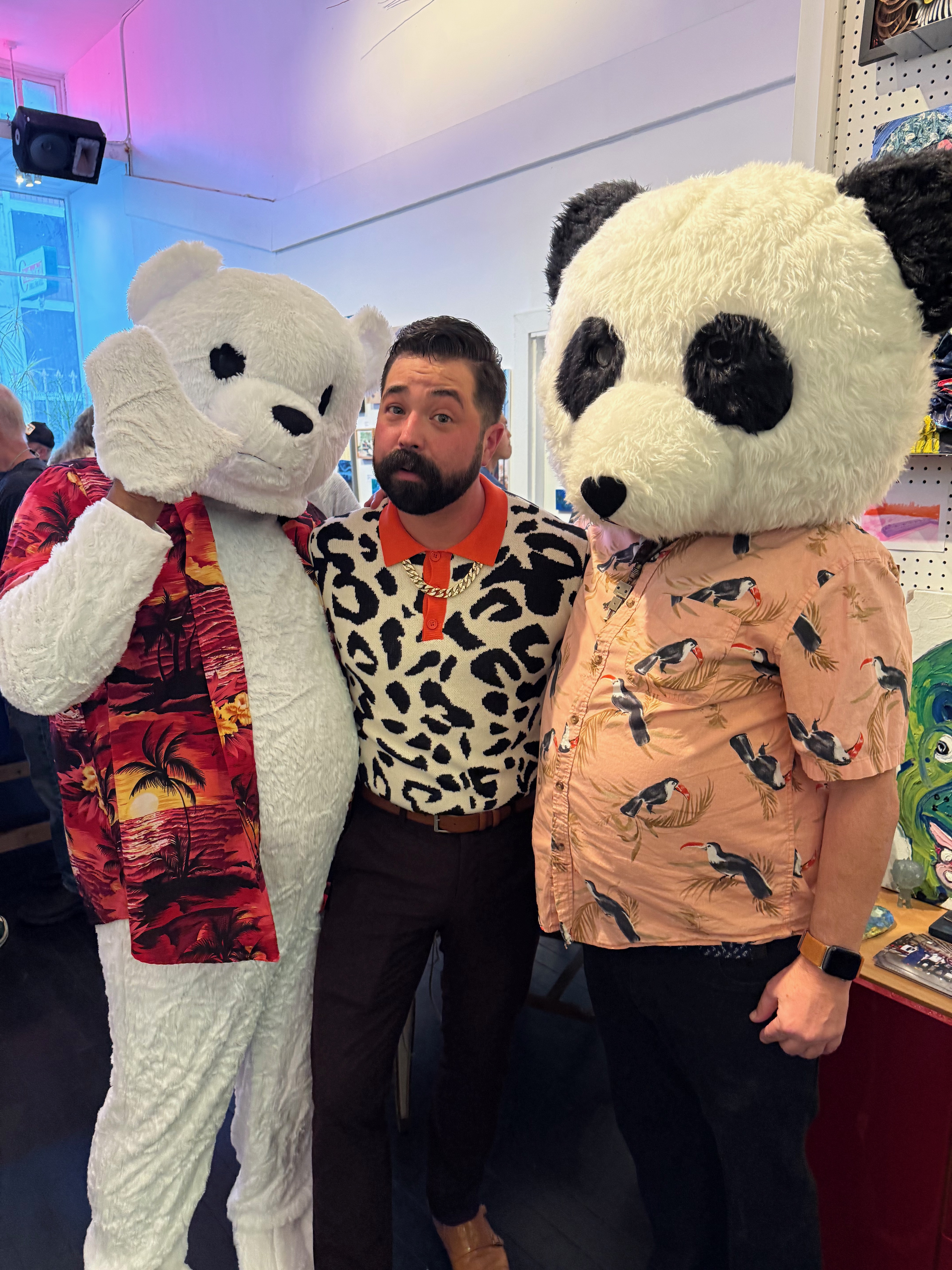 JoJo bear in a polar bear costume; Cabure Bonugli, the gallerist at Rosebud Gallery; and Charles in a panda bear head posing at the opening for the Animals show at Rosebud Gallery.